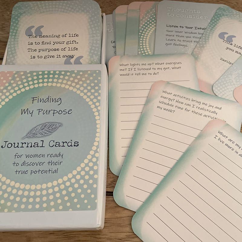 Alt text: Finding My Purpose Journal Cards – open box with self-reflection journal prompts and inspirational quote cards fanned out, including "The meaning of life is to find your gift.