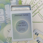 Goodbye High School Journal Cards – deck for Year 12 grads, open box with reflection card reading "Every chapter in life deserves a moment of reflection and celebration," surrounded by numbered prompt cards.