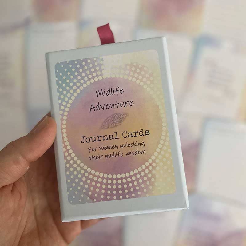 Midlife Adventure Journal Cards – deck for women unlocking their midlife wisdom, boxed set with maroon ribbon pull, held in hand.